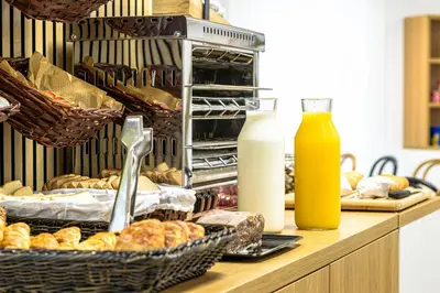 a counter with baskets of bread and bottles of milk at Alda Palas de Rei in Palas de Rei