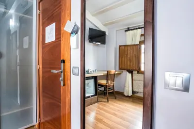 a door leading into a room with a table at Hotel Alda Bonaval in Santiago de Compostela