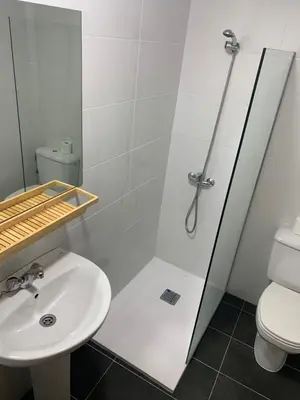 a bathroom with a shower and a sink at Pension Valcarce in Ponferrada
