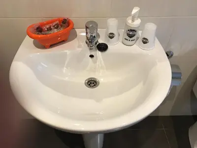 a white sink with soap and other items on it at Hostal Las Eras in Cubillos del Sil