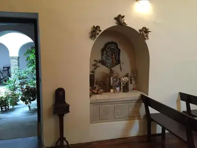 a room with a altar with a clock on the wall at Pazo Torre Do Barrio in Loseiro