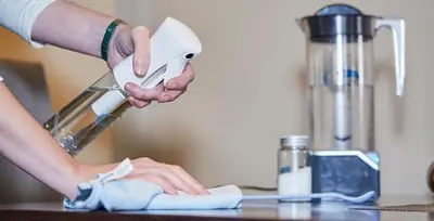 a person is holding a hand mixer on a counter at Hospedaje Jose Rey in Santiago de Compostela