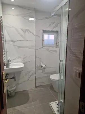 a bathroom with a toilet and a sink and a shower at Hospedaje Jose Rey in Santiago de Compostela