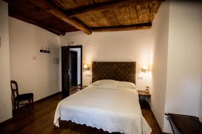 a bedroom with a large white bed in a room at La Casa Grande Del Valle in El Valle