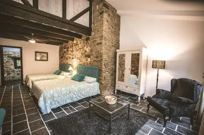 a bedroom with a bed and a chair at La Casa Grande Del Valle in El Valle