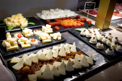 a bunch of different types of cheese and vegetables at Parador de Monforte de Lemos in Monforte de Lemos