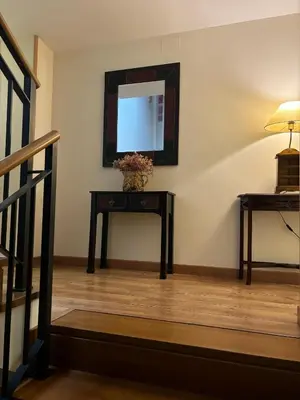 a room with a table with a mirror and a television at Hotel Molina Real in Molinaseca