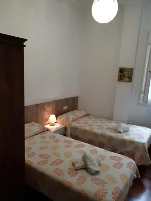 a bedroom with two beds with towels on them at Pensión Hedrass in Santiago de Compostela