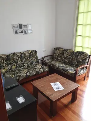 a living room with two couches and a coffee table at Pensión Hedrass in Santiago de Compostela
