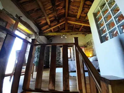 a wooden staircase in a house with a wooden ceiling at Galicia Retreat in Santa Marta de Ortigueira