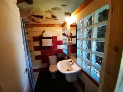 a small bathroom with a sink and a toilet at Galicia Retreat in Santa Marta de Ortigueira
