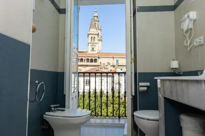a window in a room with a view of two buildings at Casa Celsa-Barbantes in Santiago de Compostela