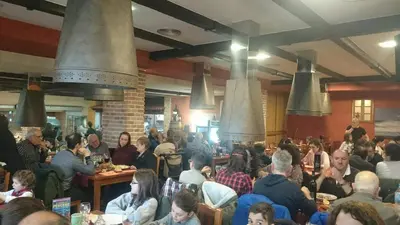 a crowd of people sitting at tables in a restaurant at Apartamento Viveiro, Terraza Grande, 2 dormitorios 2 baños, piscinas, parking, tenis, club social in Jove