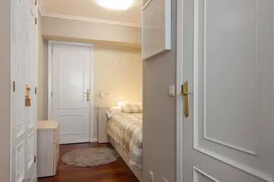 a bedroom with a bed and a door to a room at Pension Residencia F&F in Santiago de Compostela