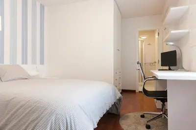 a bedroom with a bed and a desk and a computer at Pension Residencia F&F in Santiago de Compostela
