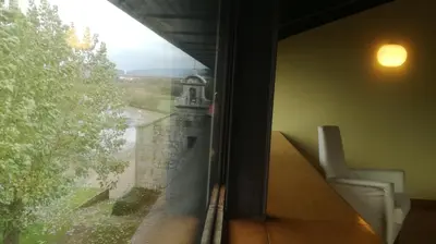 a window of a room with a view of a building at Pazo da Merced in Neda