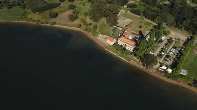 an aerial view of a house next to a body of water at Pazo da Merced in Neda
