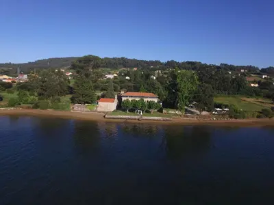 an island in the middle of a body of water at Pazo da Merced in Neda