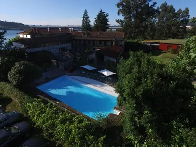 an overhead view of a swimming pool in front of a house at Pazo da Merced in Neda