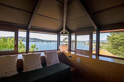 a room with a couch with a view of the water at Pazo da Merced in Neda