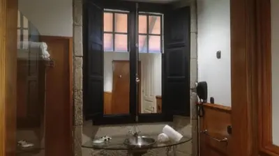 a bathroom with a sink and a mirror at Pazo da Merced in Neda