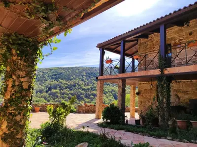 a view from the outside of a house with the mountains in the background at Lugar dos Devas in Covelo