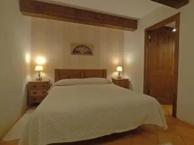 a bedroom with a large bed and two night stands at Lugar dos Devas in Covelo