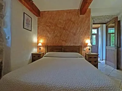 a bedroom with a large bed with two night stands at Lugar dos Devas in Covelo