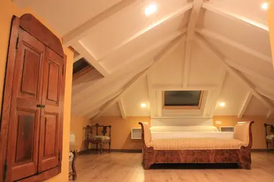 a bedroom with a bed and a tv on the ceiling at Hostal Siglo XIX in Cacabelos