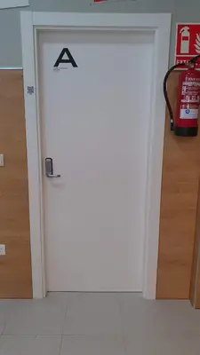a door with a sign on it in a room at Albergue Turistico la Credencial in Santiago de Compostela