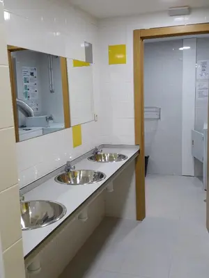 a bathroom with three sinks and a mirror at Albergue Turistico la Credencial in Santiago de Compostela