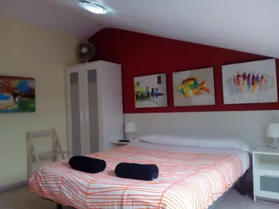 a bedroom with a bed with two black towels on it at Albergue Aqua Portomarin in Portomarin