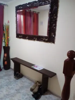 a mirror on a wall with a bench in a room at Albergue Aqua Portomarin in Portomarin
