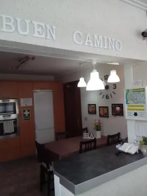a dining room and kitchen with a table and chairs at Albergue Aqua Portomarin in Portomarin
