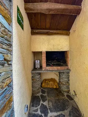 a stone fireplace in the side of a building at Casa Ría de Navia in Navia