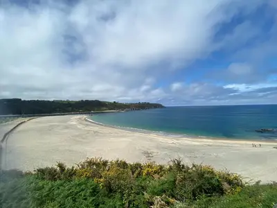 a view of a sandy beach with the ocean at Casa Ría de Navia in Navia
