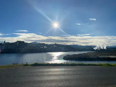 a view of a river with the sun in the sky at Casa Ría de Navia in Navia