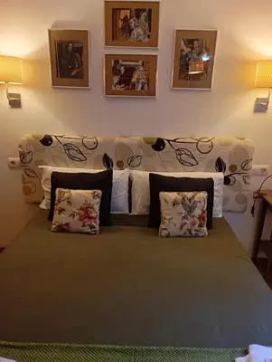 a bedroom with a large bed with pillows at Apartamentos el Camino in Villafranca del Bierzo
