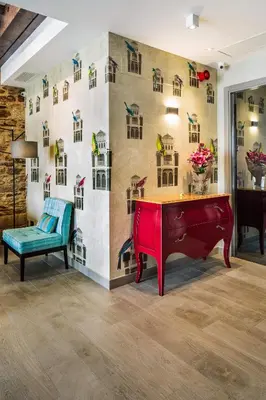 a red piano in a room with a wall with buildings at Hotel Atalaia in Santiago de Compostela