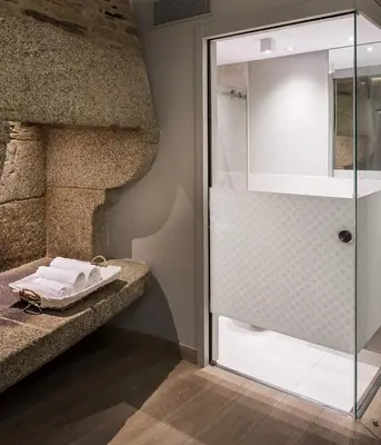 a bathroom with a shower with a glass door at Hotel Atalaia in Santiago de Compostela