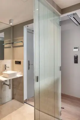a glass shower in a bathroom with a sink at Hotel Atalaia in Santiago de Compostela