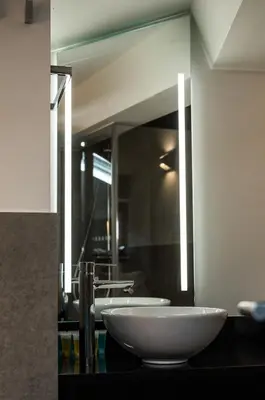 a bathroom with two sinks and a large mirror at Hotel Atalaia in Santiago de Compostela