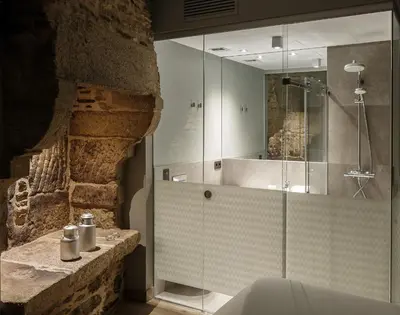 a bathroom with a glass shower and a sink at Hotel Atalaia in Santiago de Compostela
