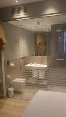 a bathroom with a glass shower and a sink at Hotel Atalaia in Santiago de Compostela