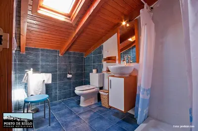 a bathroom with a toilet and a sink and a shower at Porto de Rinlo in Rinlo