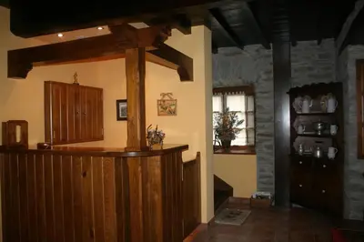 a room with a bar in a building at Apartamentos Rurales El Palacio de Doiras in Boal