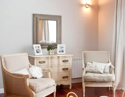 two chairs in a room with a dresser and a mirror at Inicia Cruceiro do Galo in Santiago de Compostela