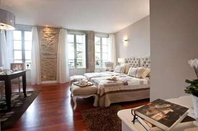 a bedroom with a bed and a table in a room at Inicia Cruceiro do Galo in Santiago de Compostela
