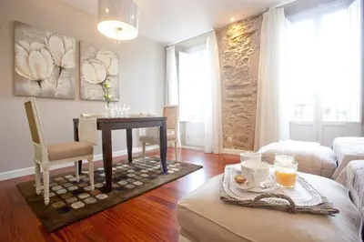a living room with a table and a couch at Inicia Cruceiro do Galo in Santiago de Compostela