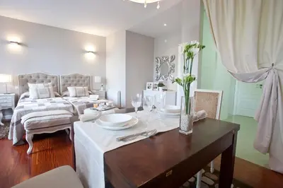 a living room with a table and a bed at Inicia Cruceiro do Galo in Santiago de Compostela